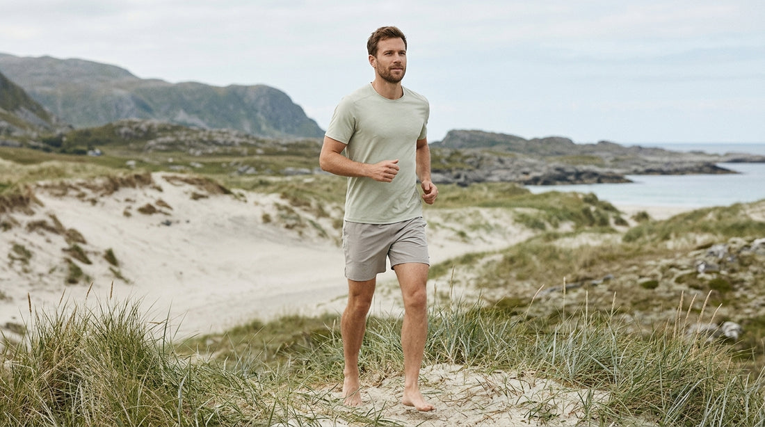 Man wearing premium sustainable training shorts outdoors in Nordic summer light