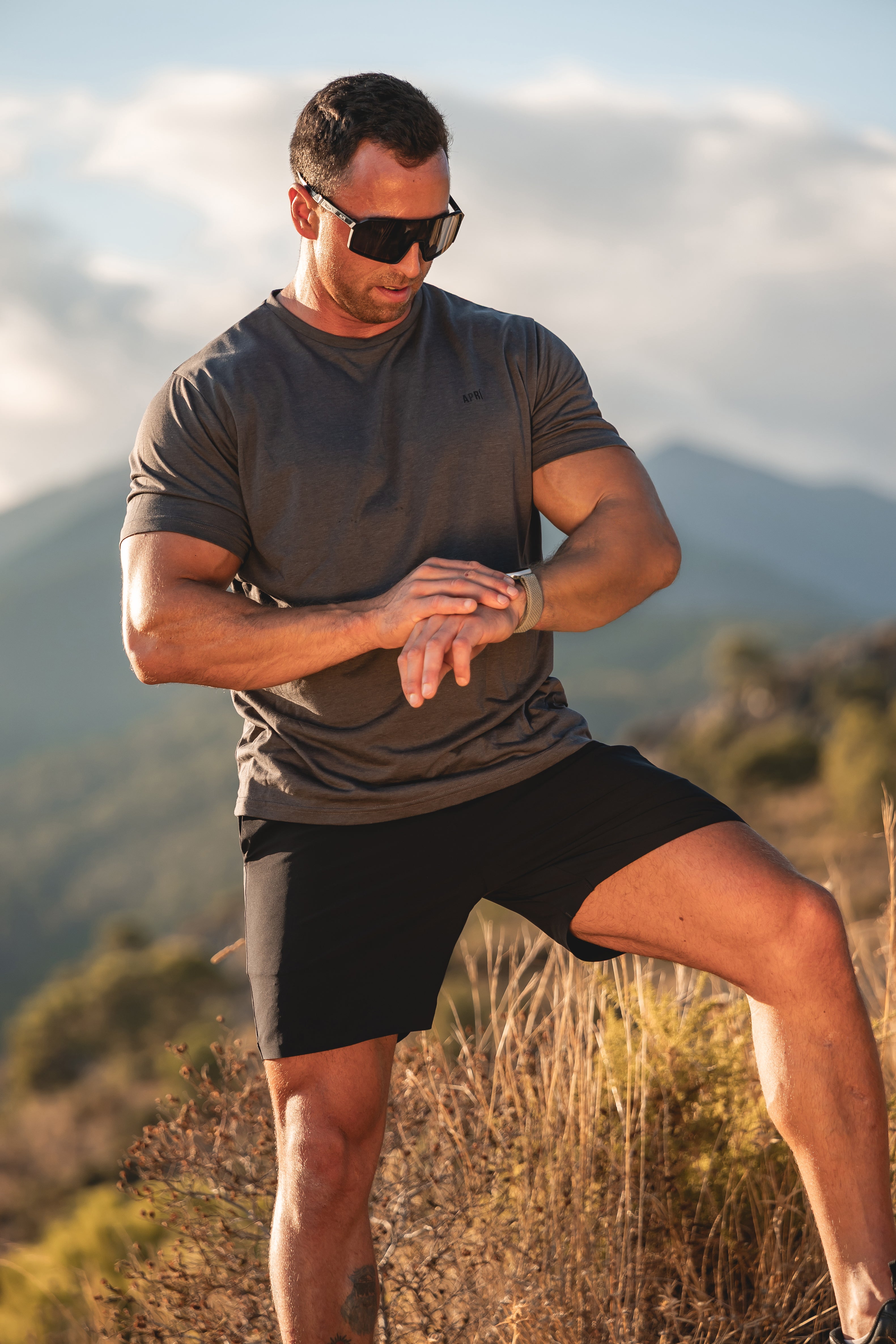 Man in Asphalt Lyocell T-shirt running in the mountains