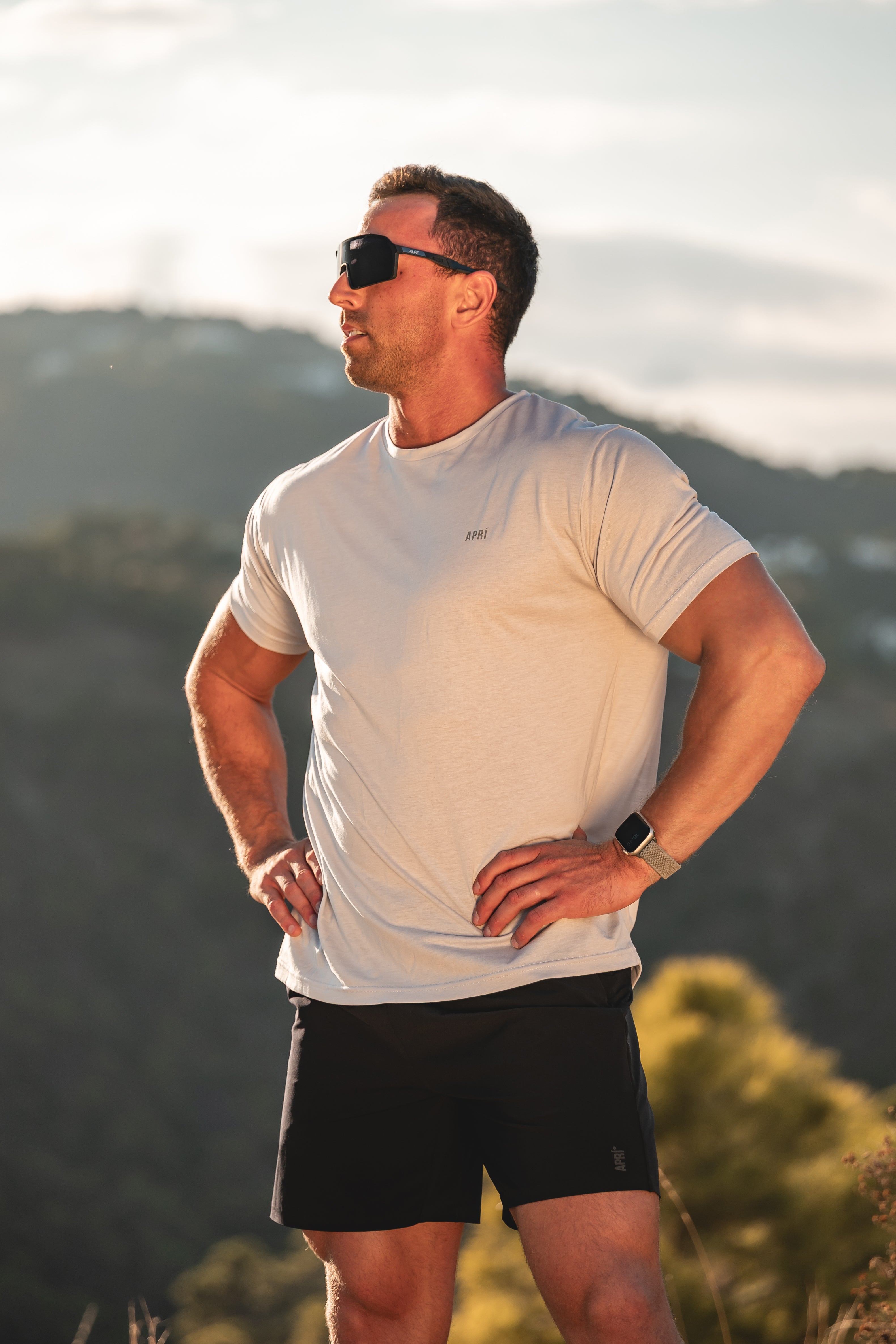 Man in athletic wear standing outdoors with mountains in the background. Luna Rock Grey Lyocell T-shirt Running.